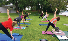 People stretch at Donation Yoga Excelsior on Lake Minnetonka.