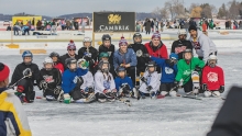 Players from the North American Pond Hockey Championship gather on the ice.