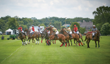 Riders on horses go for the ball during a Twin City Polo Club match.