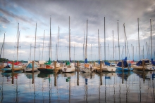 Sailboats float in the harbor at Wayzata Bay as a storm approaches Lake Minnetonka.