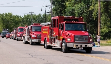 Firetrucks lined up for a parade.