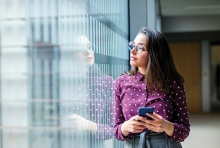 A woman browses social media on her phone