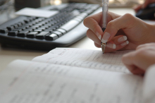 A businesswoman checks off items on her to-do list.