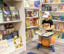 Young boy looking at books at bookstore The Thinking Spot.