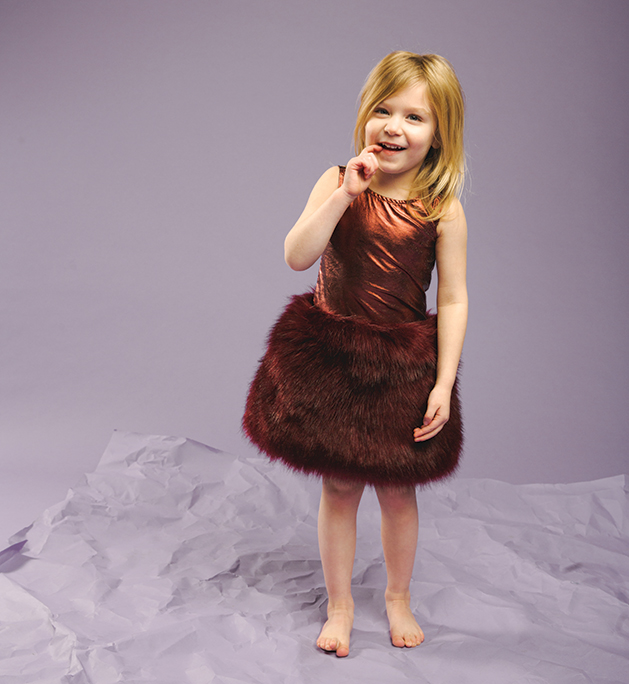 A child models clothing from Honey P's