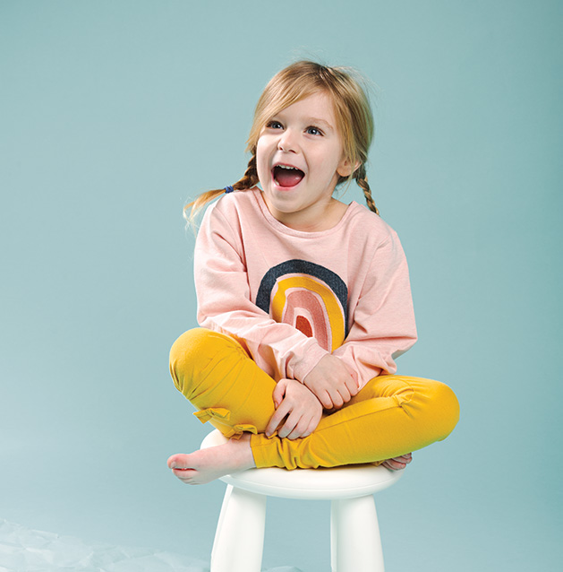 A child models clothing from Oh Baby!