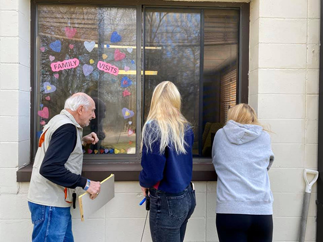 A family visits their mother at a nursing home during the coronavirus pandemic.