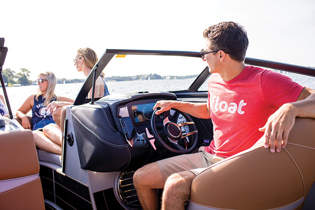 A man from Float drives a boat on Lake Minnetonka