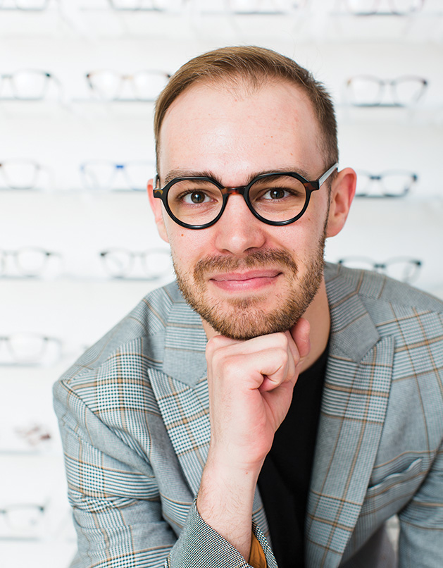 A customer models a pair of eyeglasses from Eyebobs at Ridgedale Mall