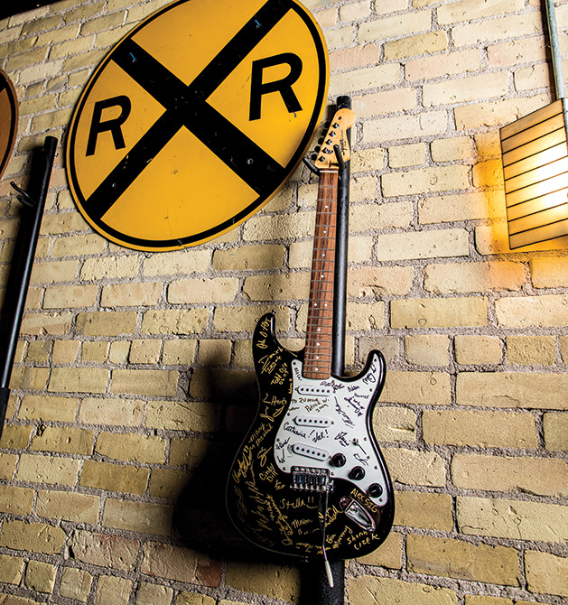 A guitar hangs on the wall at The Freight Room (formerly known as The Depot).