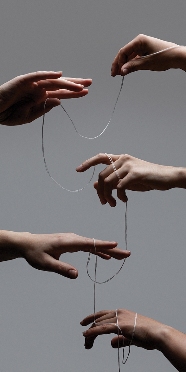 Several hands hold a string