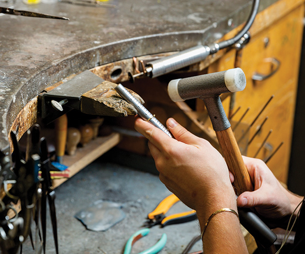 A jewelry designer crafts a ring at Veberod Gem Gallery