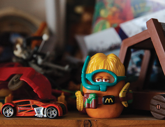 A toy car and toy McDonald's chicken nugget on C. Ray Frigard's shelf
